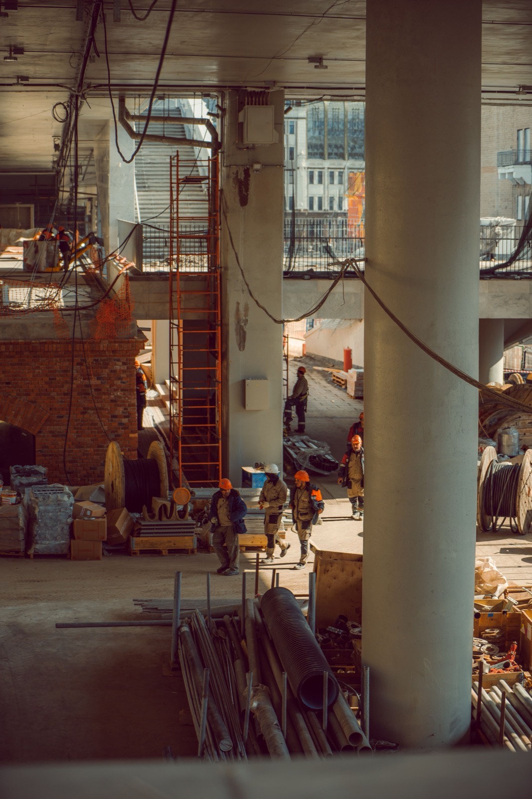 Trades crew working on a multi-storey construction site at sunset