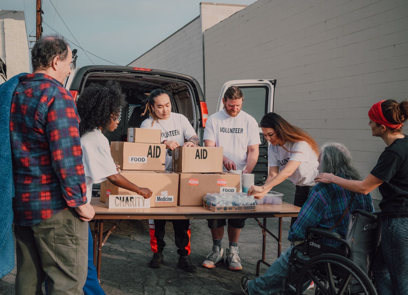 Volunteers unloading and sorting aid boxes at a community distribution