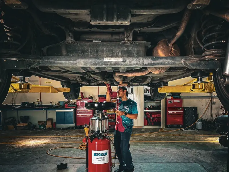 Mechanic working under a car on a lift